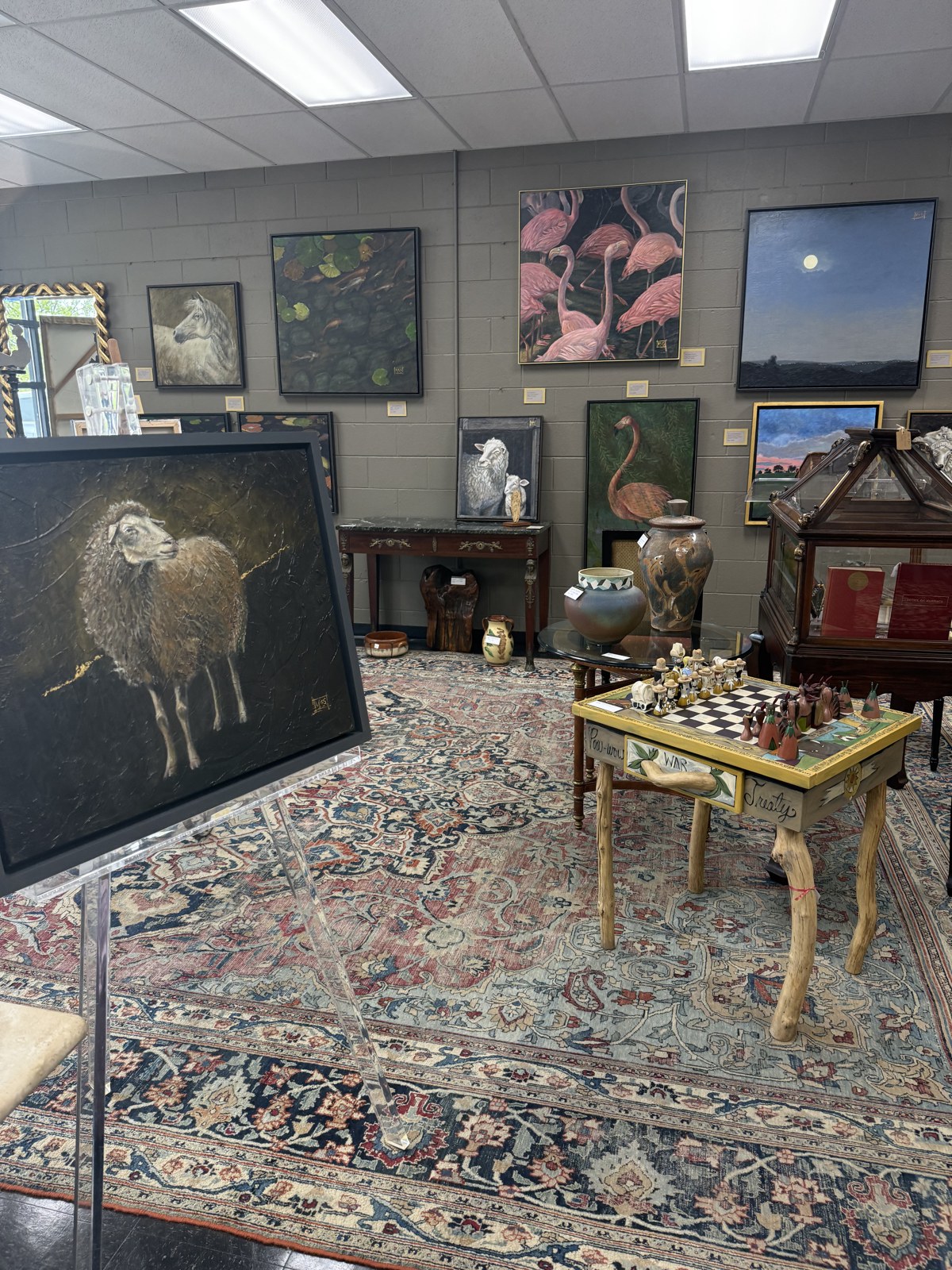 Schow's gallery interior with paintings and rugs